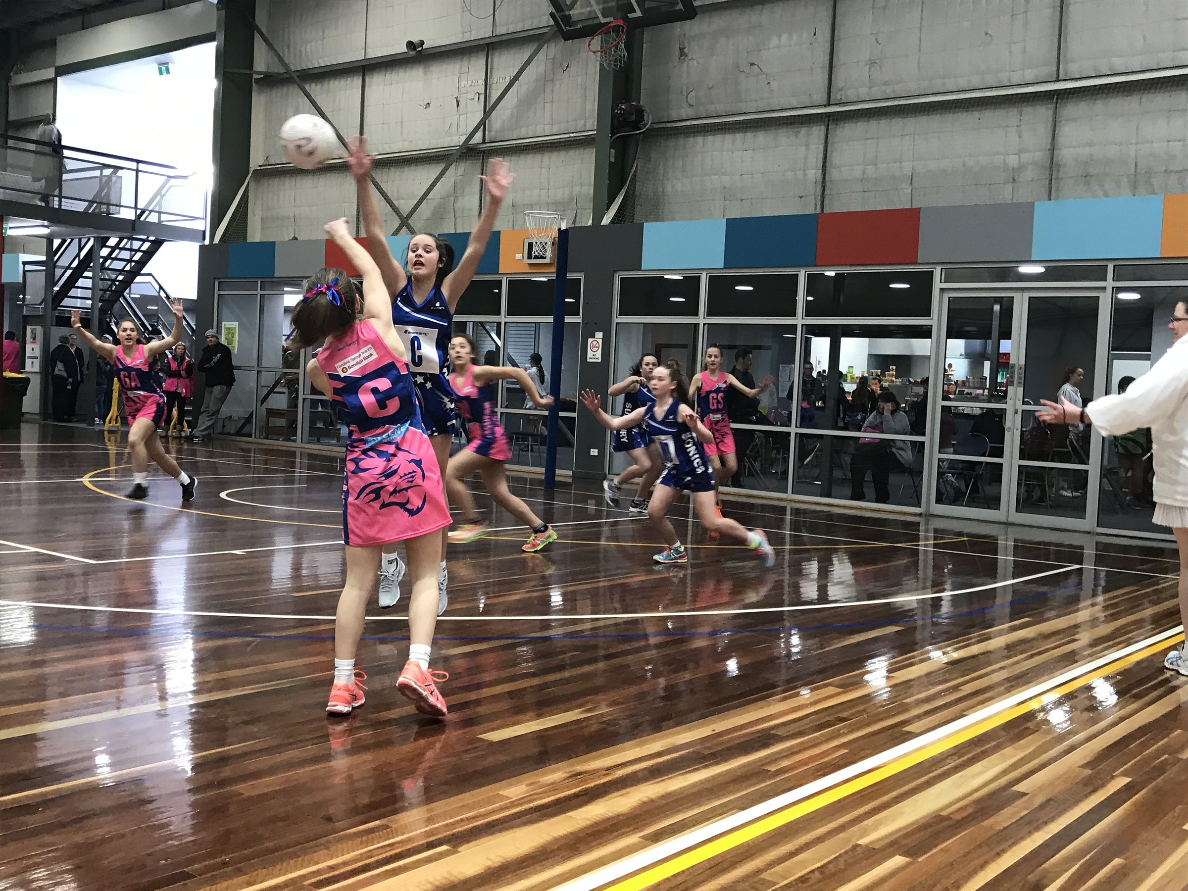 Jaguars players in pink passing the ball during a game