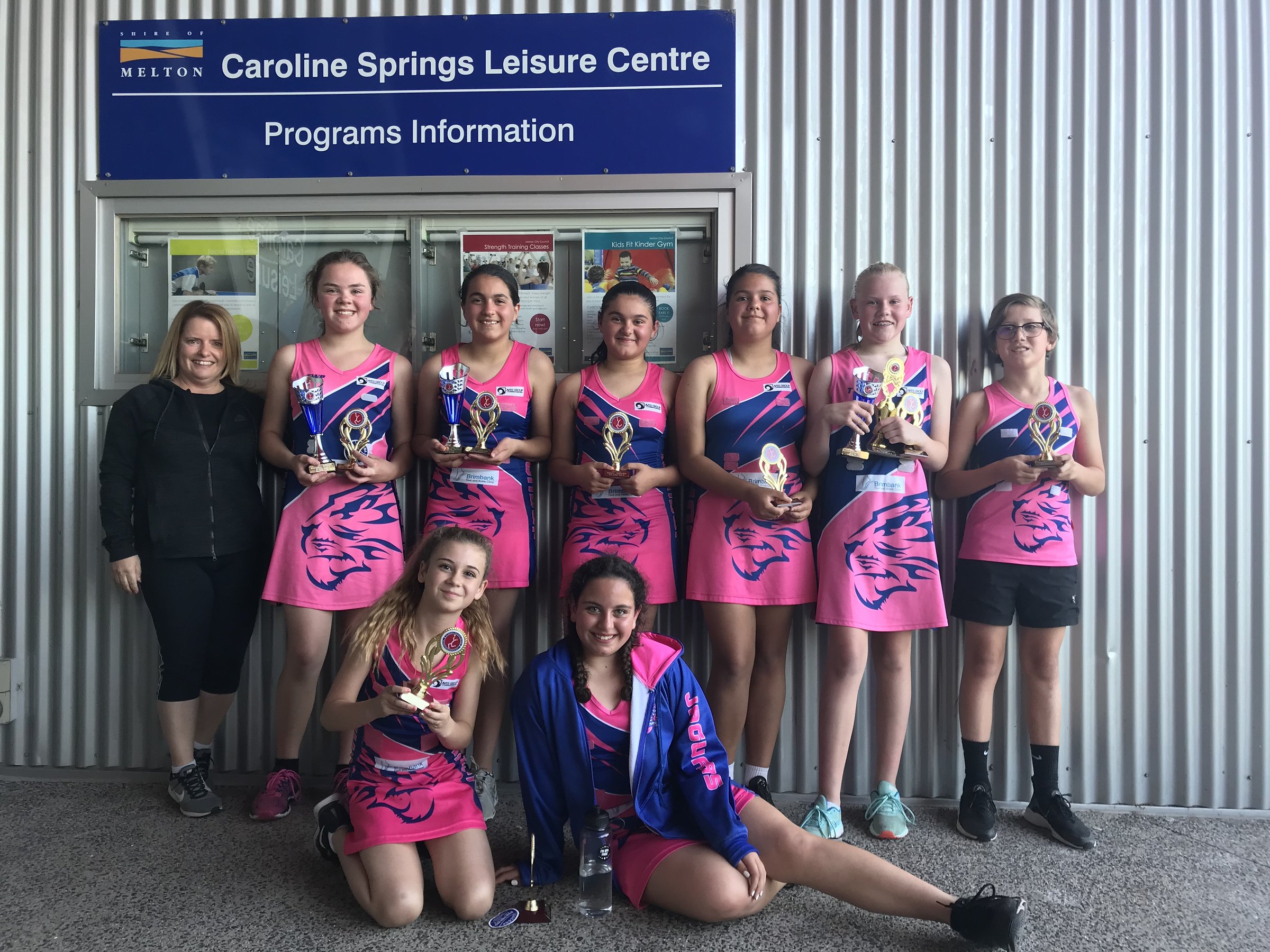 A Jaguars team with their trophies outside Caroline Springs Leisure Centre